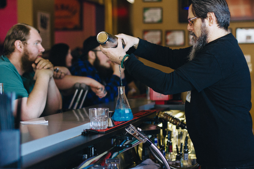 A bartender mixing a drink.